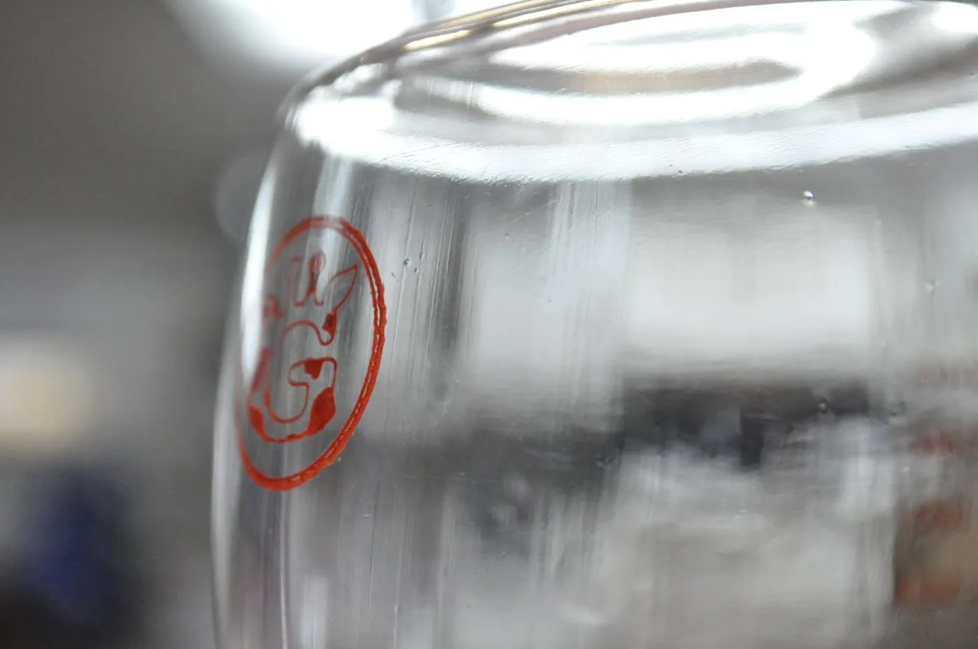 First-off blow molded bottle body with the brand mark pad printed on it