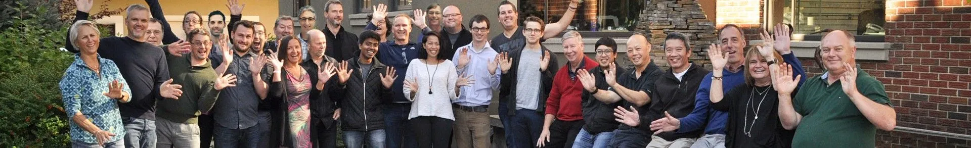 The Design 1st team waving outside the office