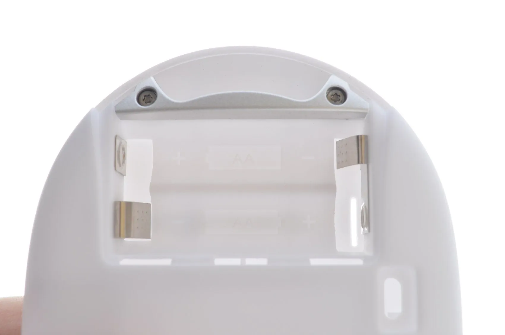 Close-up of the empty battery bay inside the enclosure, marked for two AA cells