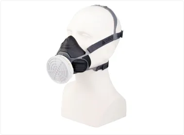 Black half-face respirator with a grey filter cartridge on a white mannequin head