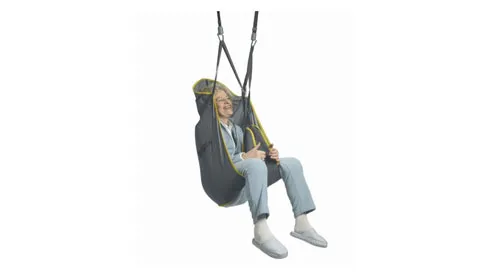 Person seated in an Invacare patient lift sling suspended from a hoist