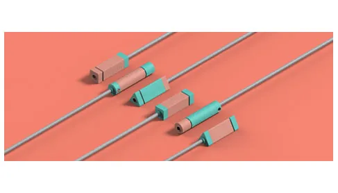 Maptic tactile navigation wearable modules in coral and teal on grey cords