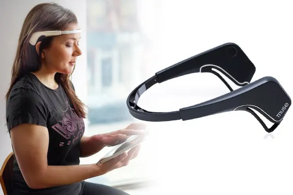 Muse brain-sensing headband beside a woman wearing it while reading a tablet