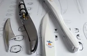 Vancouver 2010 Olympic torch and its internal metal parts laid over design sketches