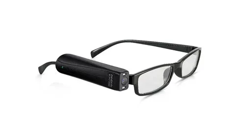 OrCam MyEye camera device clipped to the arm of a pair of glasses