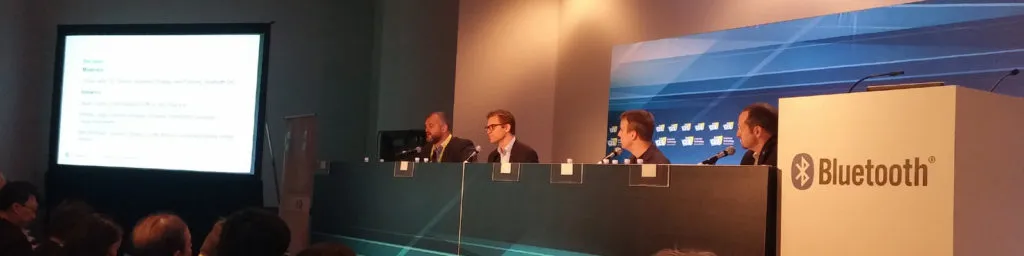 Speaker on stage in front of a slide reading IoT 1 Trillion will jump-start human evolution