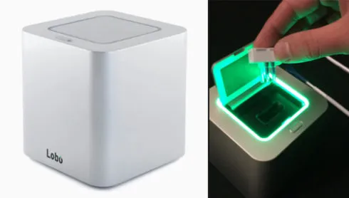 Lobo Genetics cannabis DNA test cube and a sample cartridge being inserted under a green light
