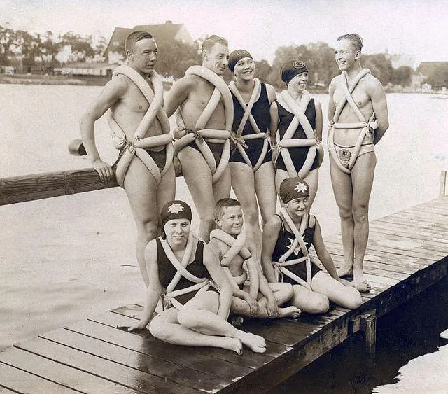 Vintage photo of swimmers on a dock wearing bicycle inner tubes as swimsuits