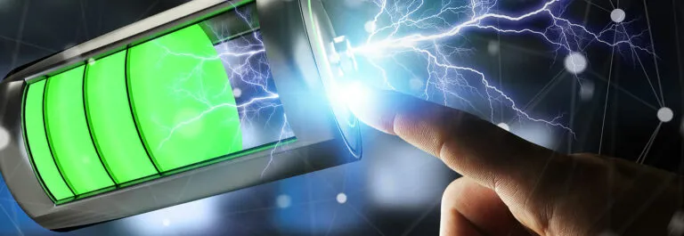 Illustration of a glowing green battery with lightning and a fingertip touching its terminal