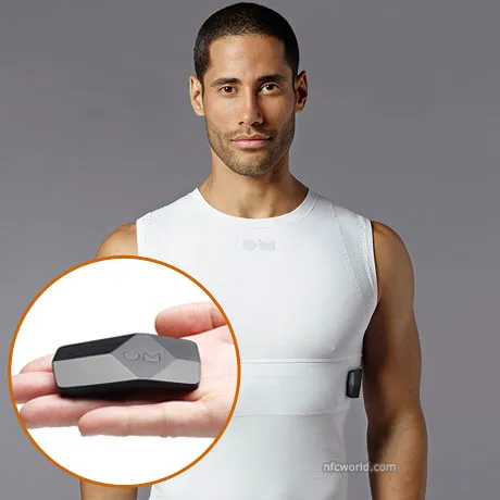 Man wearing an OMsignal biometric shirt with an inset of its small sensor module in a hand