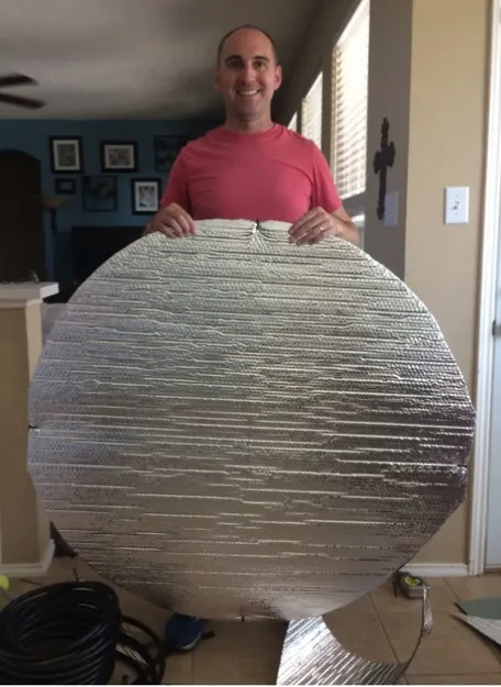 Lily Chillers founder John holding his original large foil-insulation pool cooler prototype