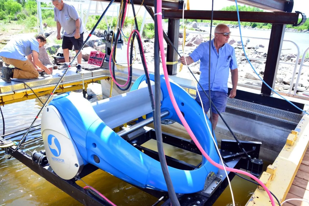 Engineers readying the Waterotor turbine prototype on a floating rig at a river test site