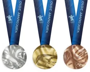 Silver, gold and bronze Vancouver 2010 Olympic medals with wavy surfaces on blue ribbons