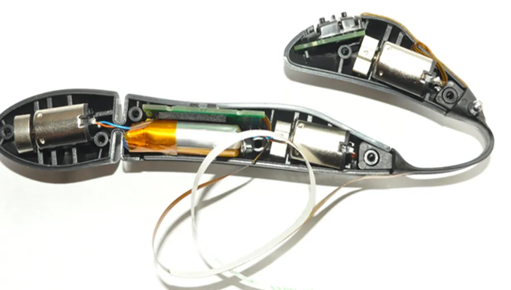 Opened Blue Dreams Feather prototype showing motors, battery, circuit board and flex cables