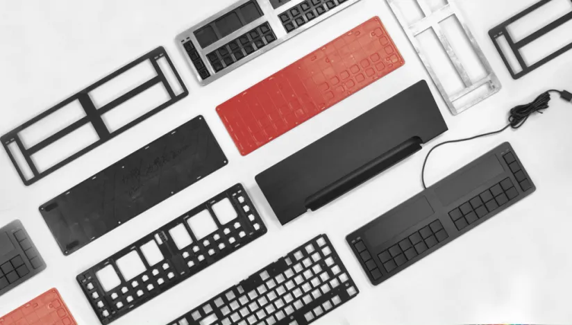 Cloud9 trading keyboard housings, frames and keypad parts laid out on a white surface