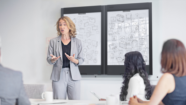 e-ink whiteboard context; woman using quirklogic whiteboard in a presentation meeting