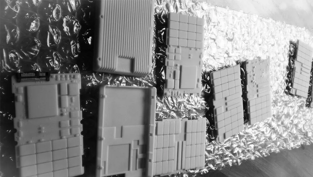 SLA prototype enclosure parts for SanDisk laid out on bubble wrap
