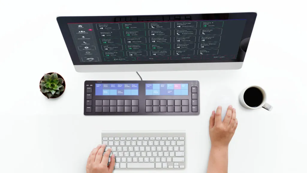Cloud9 trading keypad with two touchscreens on a desk below a monitor showing the trading dashboard