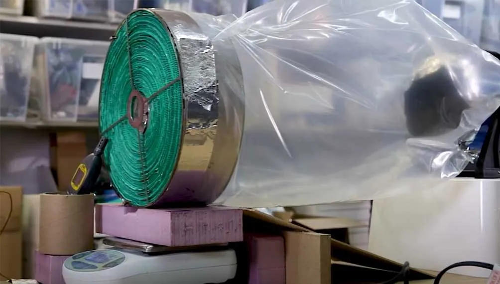 Molecule desiccant rotor prototype wrapped in foil and plastic on a scale for testing
