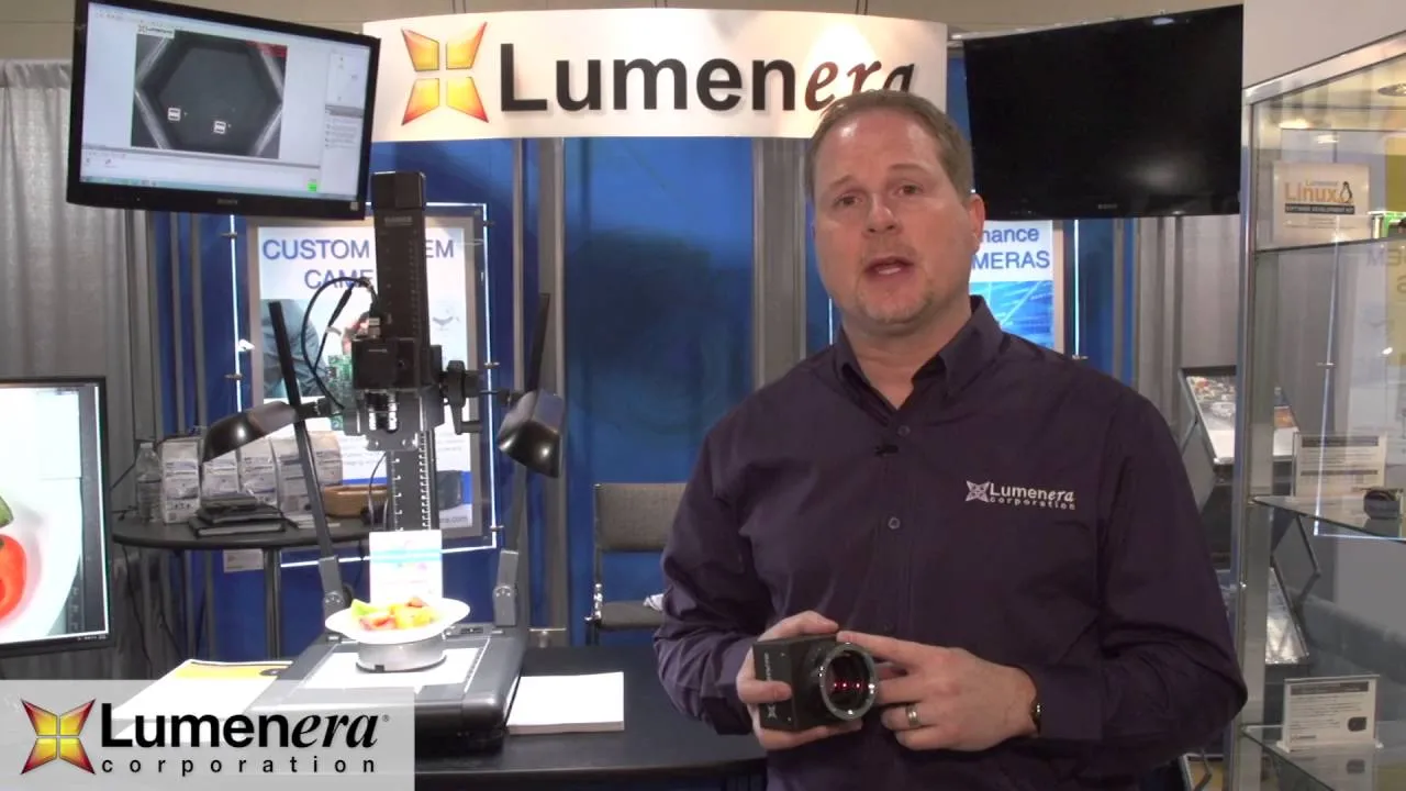 Lumenera representative holding a camera at the company trade-show booth
