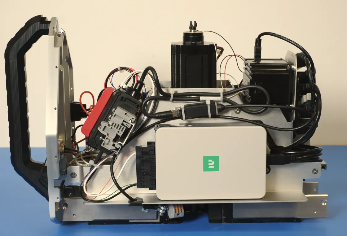 Benchtop prototype assembly with custom PCBA, motors and wiring on an aluminum frame