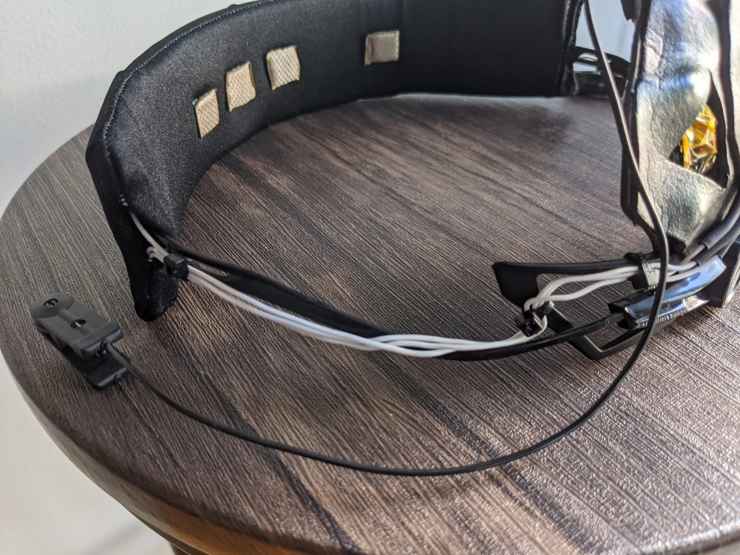 Neurovine headband prototype on a table with conductive fabric electrode patches and loose wiring