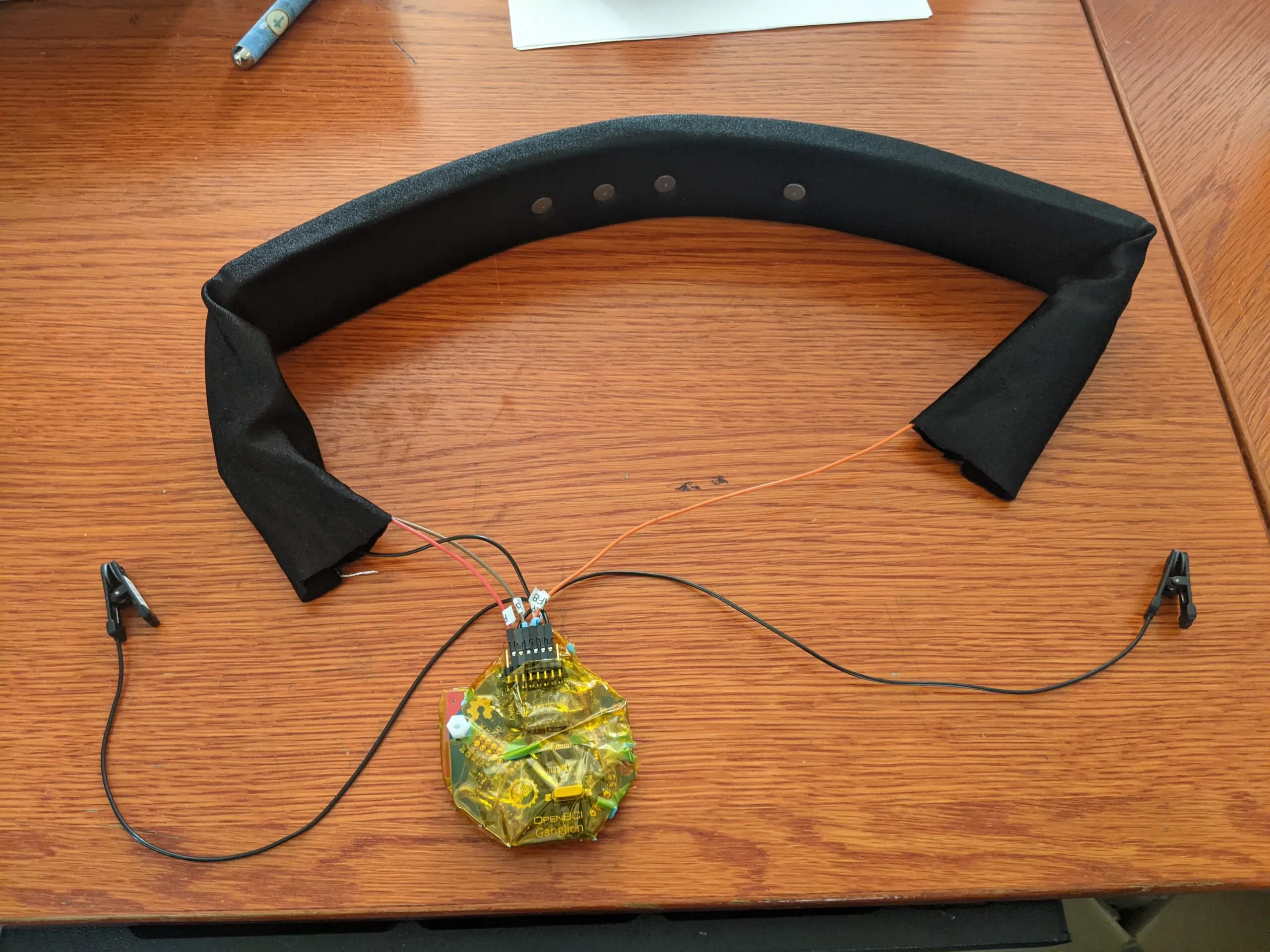 Early Neurovine foam headband prototype wired to an OpenBCI Ganglion board and ear clips