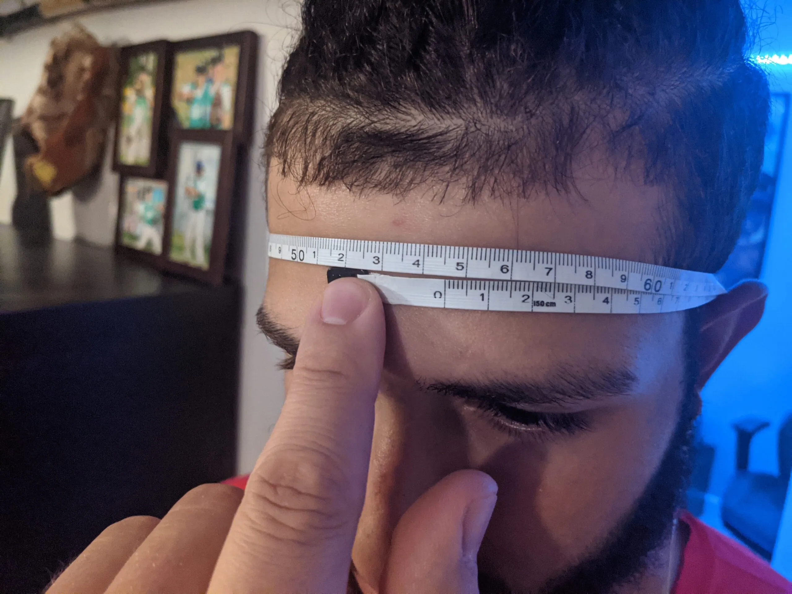 Measuring head circumference with a tape measure for Neurovine headband fit testing