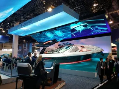 Brunswick booth at CES 2020 with a sport boat beneath a curved LED display