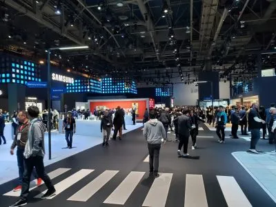 Crowd walking through the Samsung booth beneath a large LED wall at CES 2020