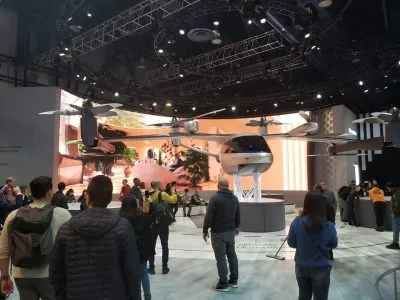 Crowd viewing a passenger air-taxi drone prototype on a raised stage at CES 2020