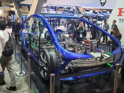 Blue exposed-chassis electric vehicle cutaway showing battery and drivetrain at CES 2020