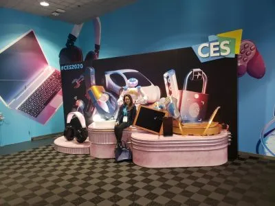Attendee posing at the #CES2020 photo backdrop wall of featured gadgets
